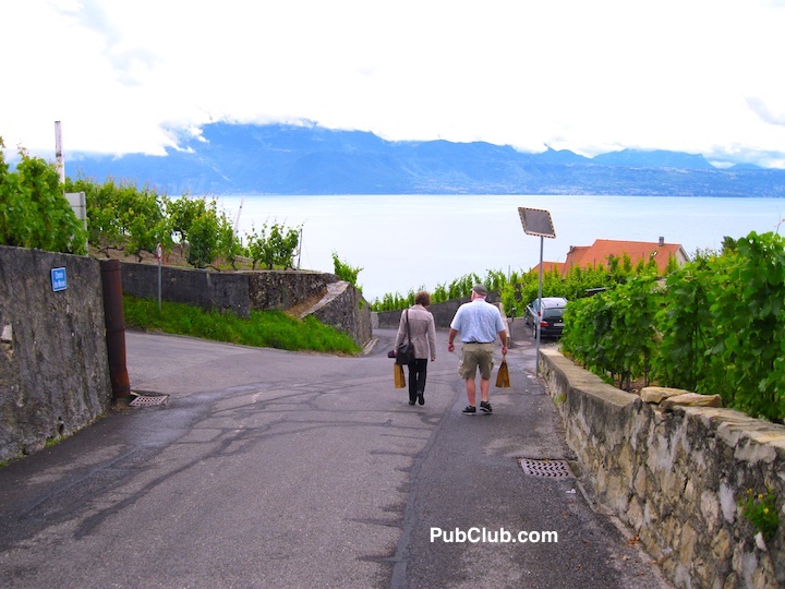 people walking on a road in Lavaux wine region Switzerland wineries