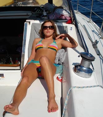 Hot girl in a bikini on a sailboat