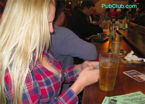 Hot blonde girl texting in a bar