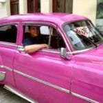 American tourist in Cuba pink car