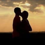Couple kissing sunset