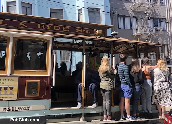 San Francisco Cable Cars people riding the rails