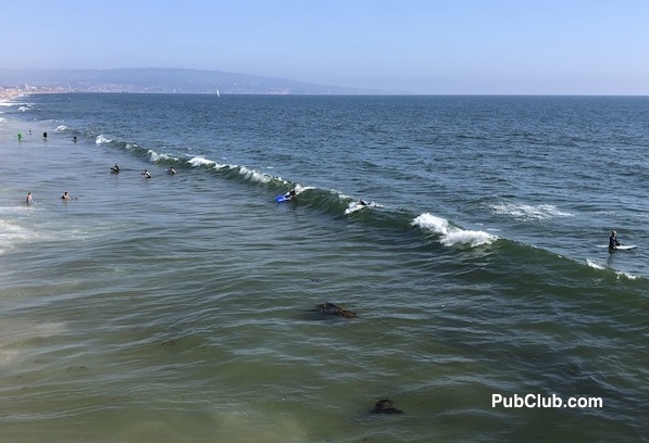 Manhattan Beach surfers catching a wave