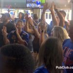 Florida Gator fans cheering in a sports bar