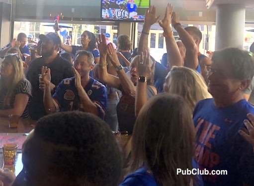 Florida Gator fans cheering in a sports bar