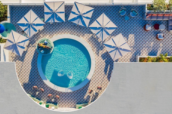 Bar Moxy Miami Beach hotel rooftop pool girl sunbathing