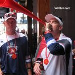fan blowing into a horn during a World Cup watch party