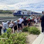people moon the passing train at the Mooning of the Amtrak