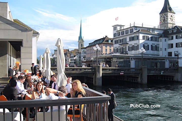 people dining along the river in Zurich Switzerland people dining along the river in Zurich Switzerland