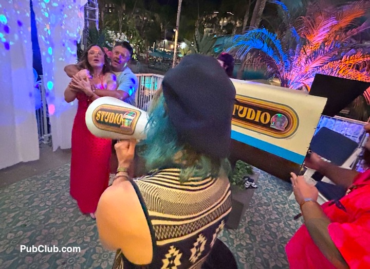 a "director" does a screen test for arriving guests at a Tiki Oasis suite party.