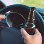 steering wheel and a beer