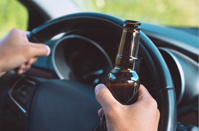 steering wheel and a beer